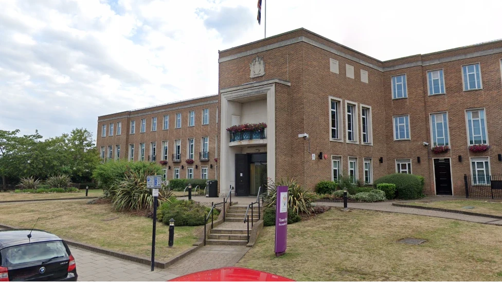 The Royal Borough of Windsor and Maidenhead council house, a mid-20th century, three storey building, with a small grassed area around it