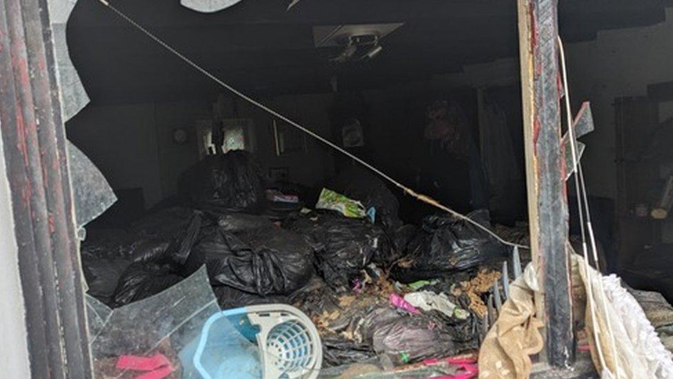 House filled with rubbish bags