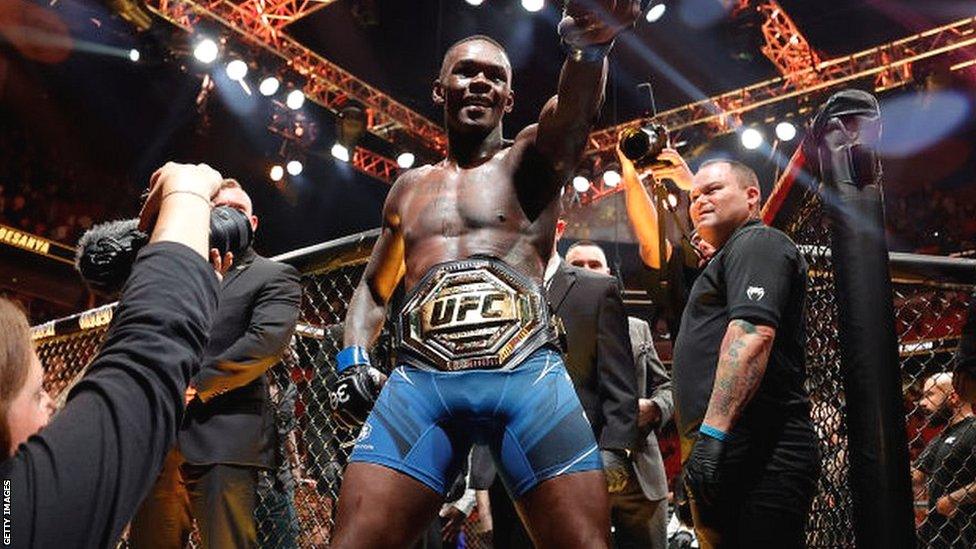 Israel Adesanya celebrates following victory over Alex Pereira