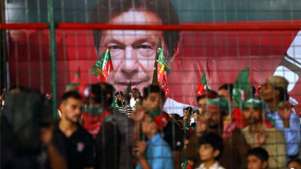 Supporters of Imran Khan, head of Pakistan Tehrik-e-Insaf (PTI) political party listen to his speech, during an election campaign in Karachi, Pakistan, 22 July 2018.