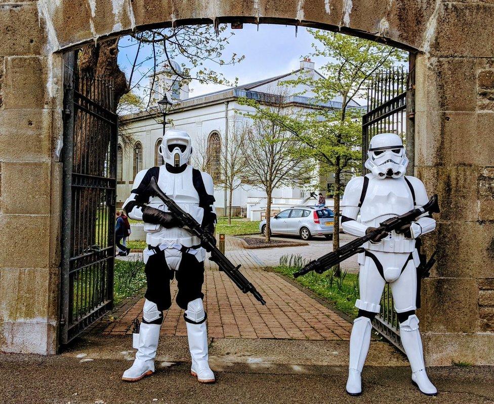 Two people dressed in stormtrooper costumes standing outside Pembroke Dock Heritage Centre