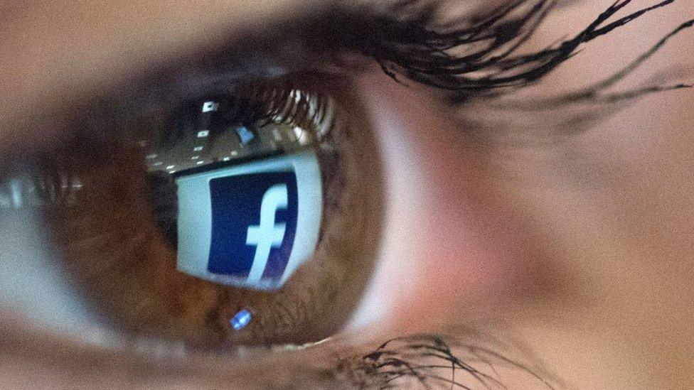 Facebook logo reflected in eye