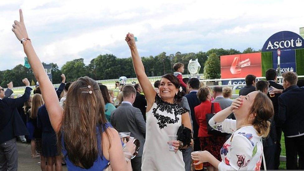 Racegoers enjoying a drink