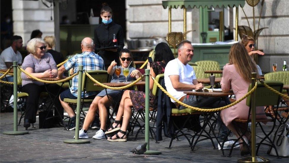 People eat in a restaurant in Covent Garden, London