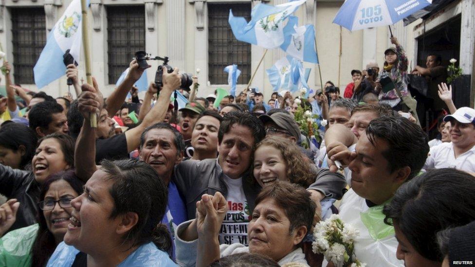 People react outside of the Guatemalan Congress building after the congress voted to strip President Otto Perez of immunity, in Guatemala City, September 1, 2015.