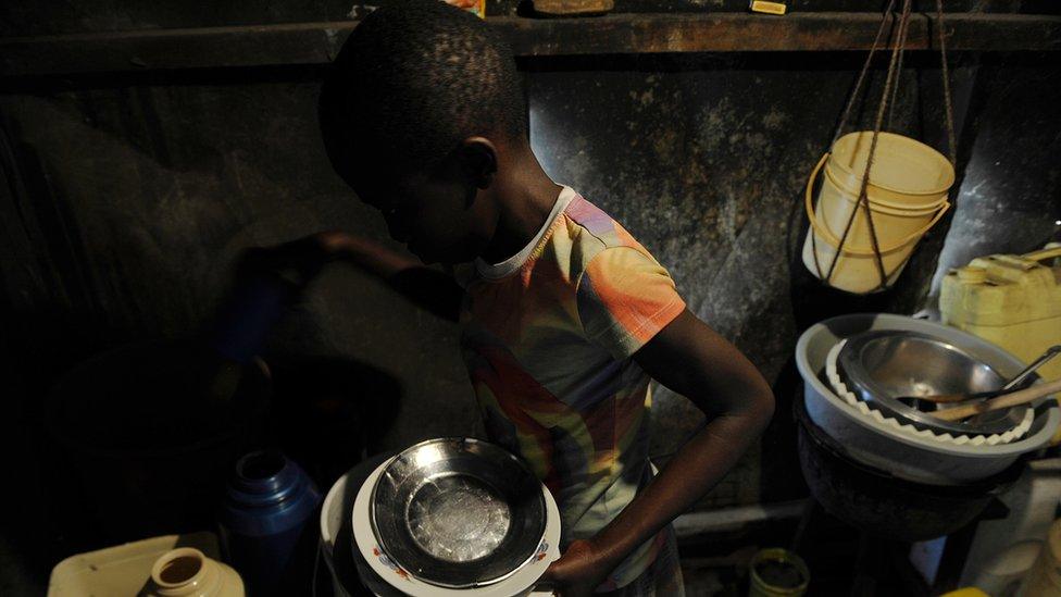 Kenyan girl in kitchen doing house chores