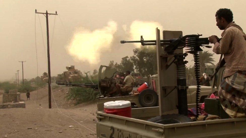 Houthi rebels fire a machine gun outside Hudaydah