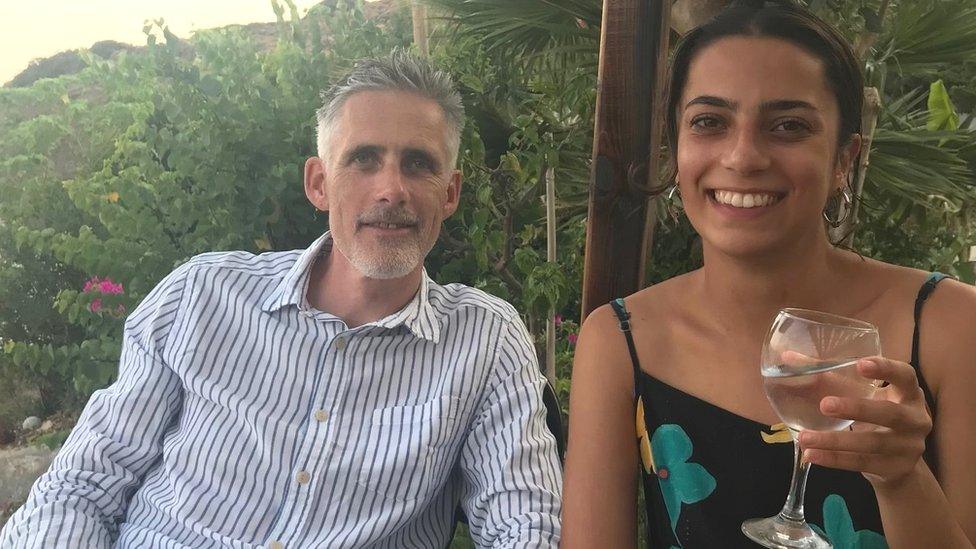 John Watling and his daughter Yasmin sitting at an outdoor table smiling