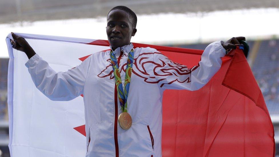 Bahrain's gold medal winner Ruth Jebet holds the Bahrain flag during the ceremony for the women's 3000-meter steeplechase final during the athletics competitions of the 2016 Summer Olympics at the Olympic stadium in Rio de Janeiro, Brazil, Monday, Aug. 15, 2016