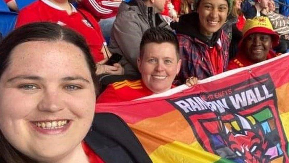 Tracy Brown and friends holding rainbow flag