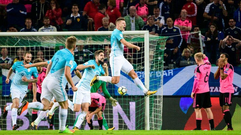 Slovenia's Roman Bezjak (jumping) celebrates