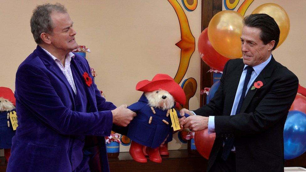 Left-right: Hugh Bonneville, Paddington, Hugh Grant