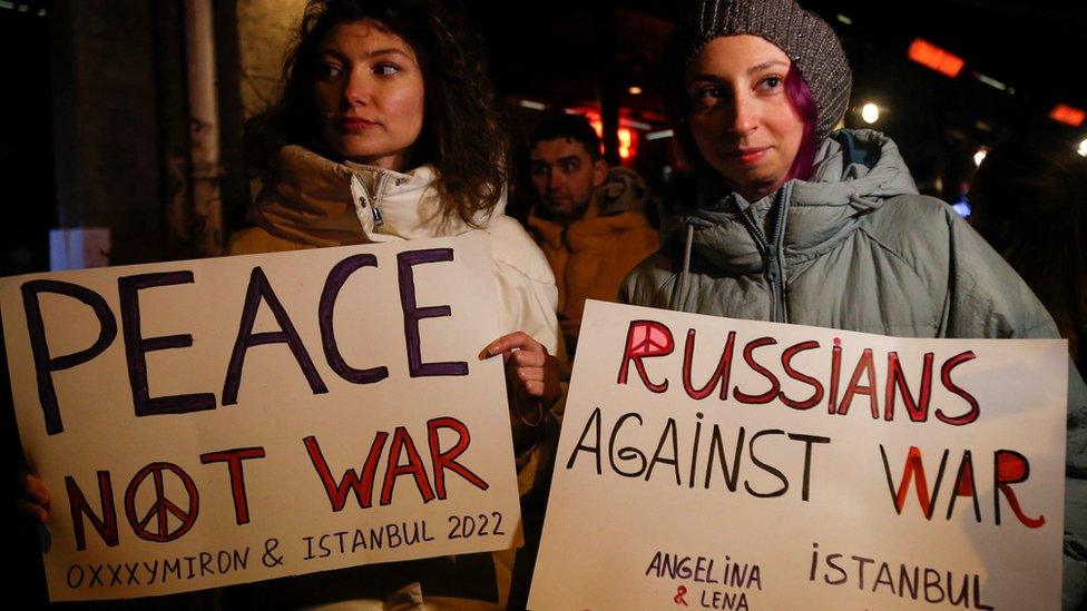 Oxxxymiron fans hold anti-war placards