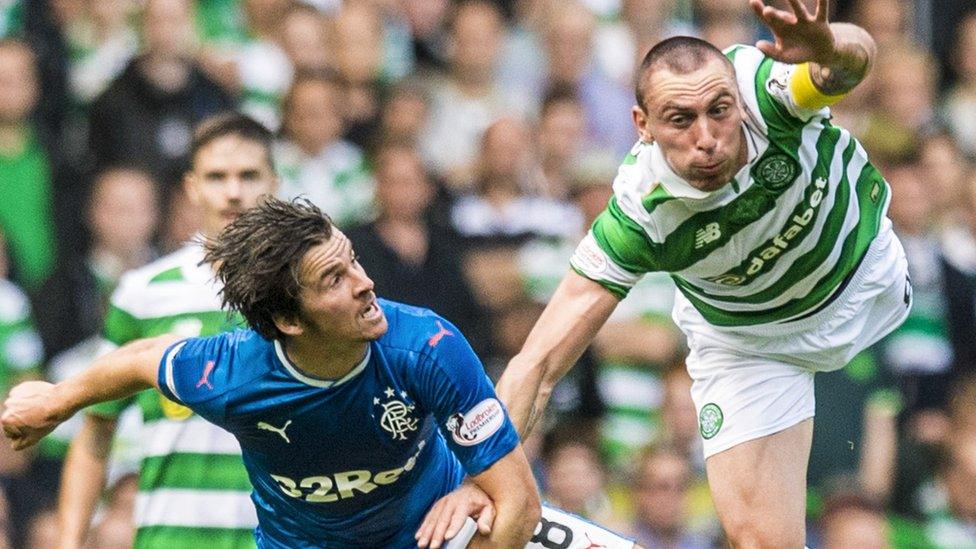 Celtic captain Scott Brown beats Rangers' Joey Barton to a high ball