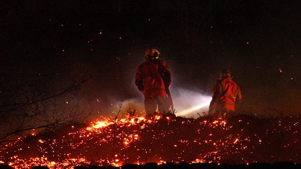 Firefighters tackling a moor fire.