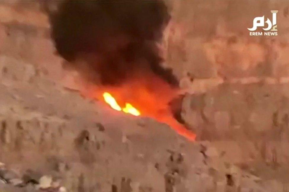 A still image taken from video footage shows a ball of flame where the helicopter crashed