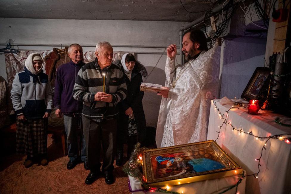 A priest leads an Orthodox Christmas mass in a basement shelter in Chasiv Yar, Eastern Ukraine, on 7 January 2023.