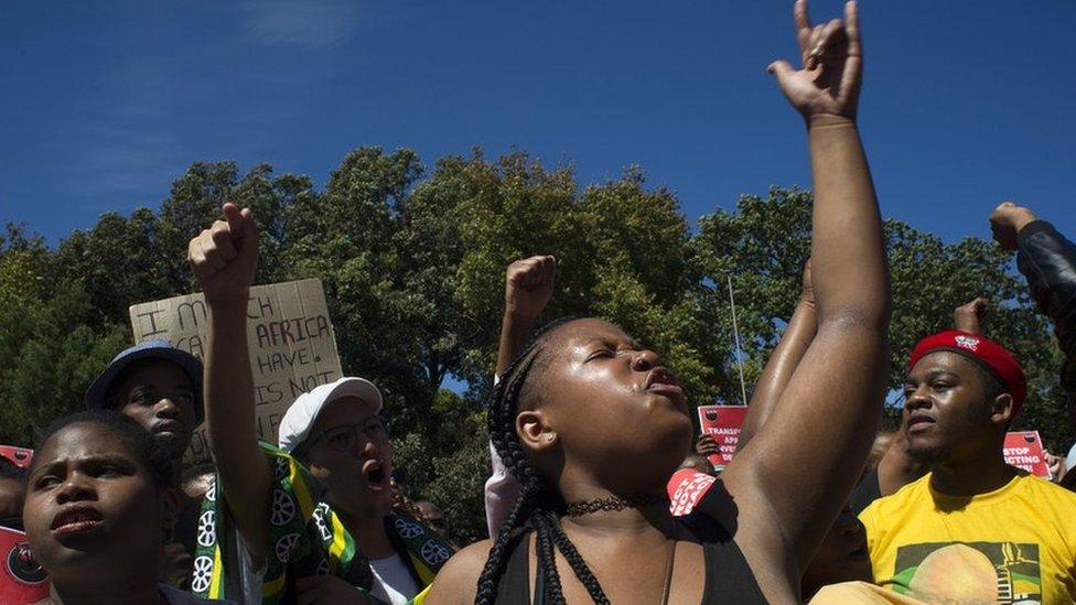 Students and staff of the University of Cape Town (UCT) protest against the statue of British coloniser Cecil John Rhodes at the university in Cape Town on 20 March 2015