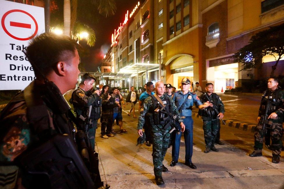 Philippine National Police Chief Ronald Dela Rosa (C) walks outside the Resorts World Manila hotel and casino complex in Pasay City, south of Manila, Philippines 2 June 2017