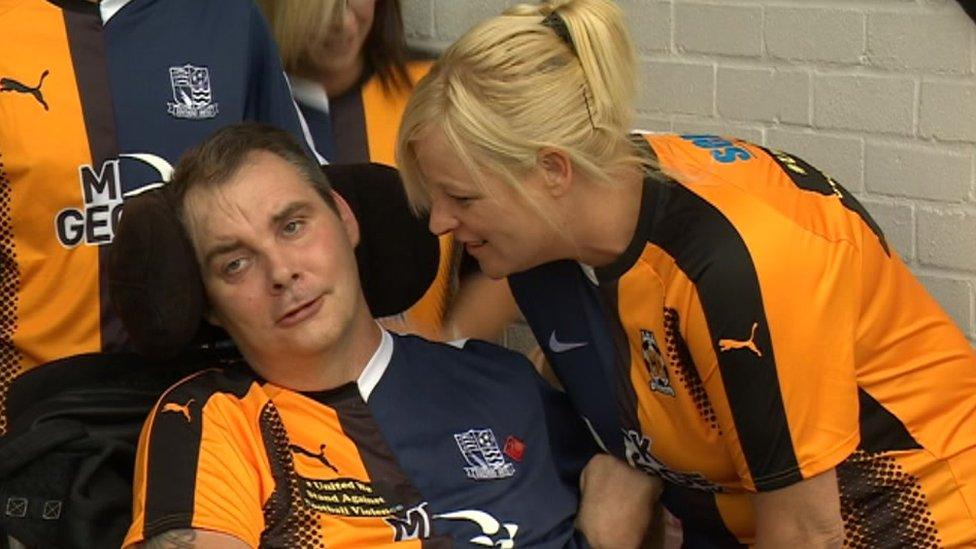 Simon Dobbin and his wife Nicole pitchside at the Cambridge United and Southend United match.