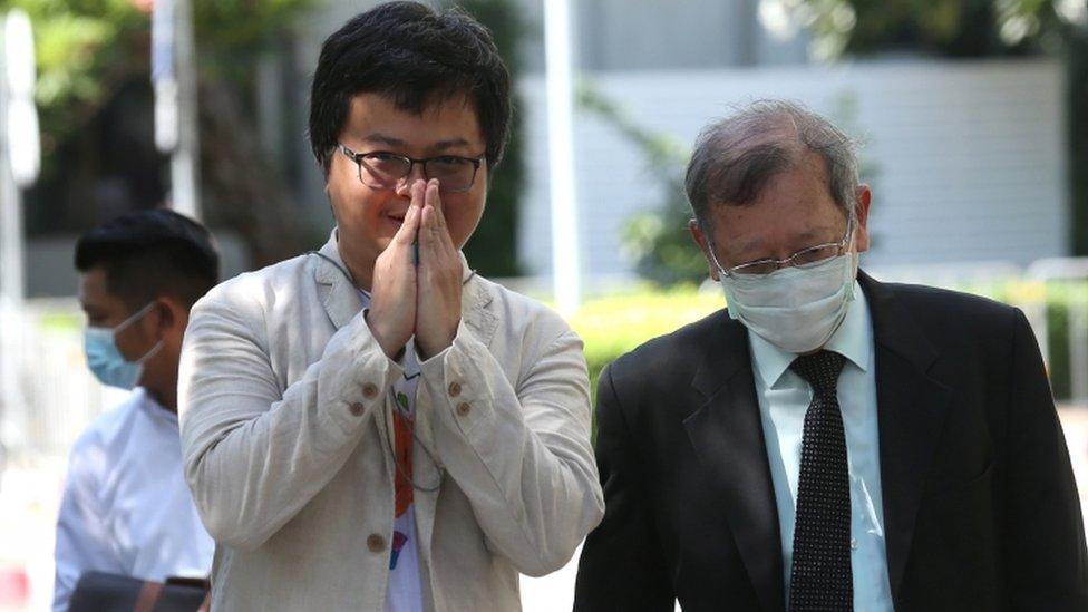 Thai lawyer and pro-democracy activist Anon Nampa (L) arrives at the Criminal Court in Bangkok, Thailand