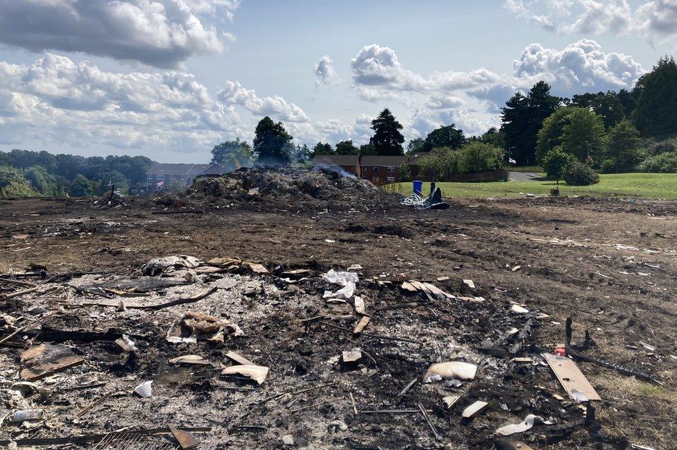 The remnants of an Eleventh night bonfire at Forthriver in Belfast