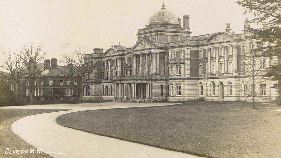 Maharajah Duleep Singh exhibition. Old image of Elveden Hall. It is a stately home with a path and grass outside it.