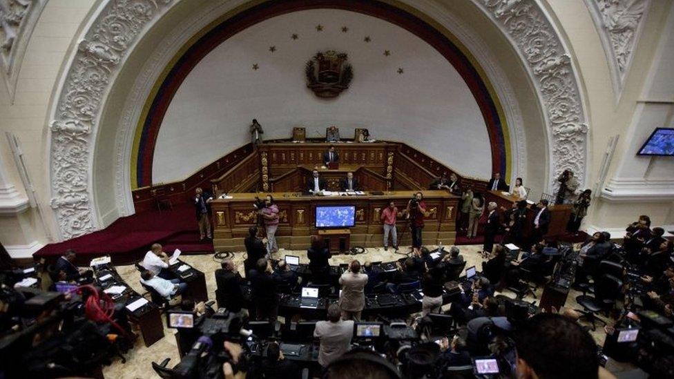 Opposition lawmakers applaud during a session at the National Assembly in Caracas, Venezuela, Monday, Jan. 9, 2017