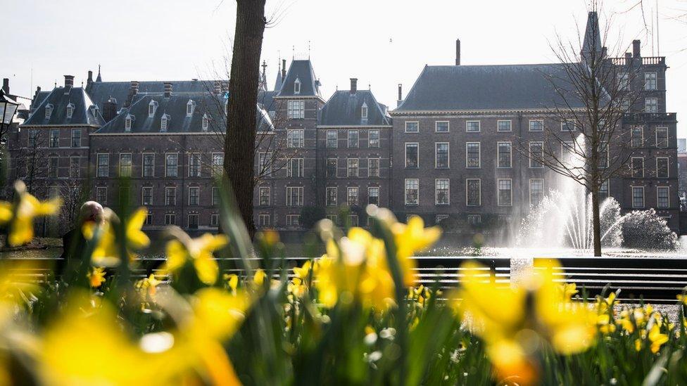 The Dutch parliament building with flowers in front of it