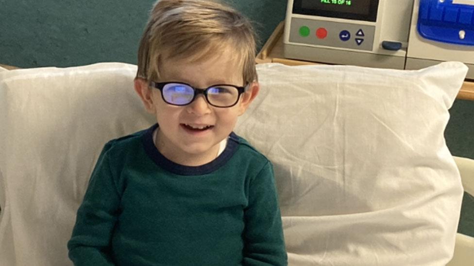 William sitting up in a hospital bed after his transplant surgery