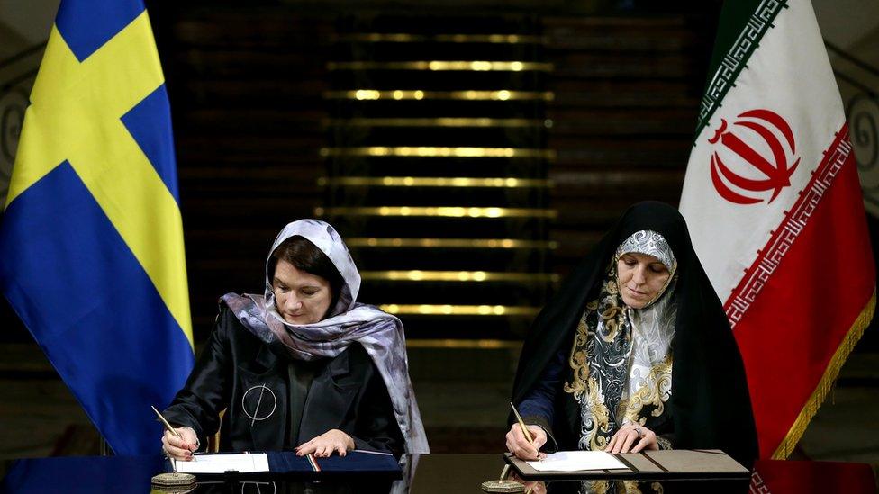 Sweden"s Minister for EU Affairs and Trade Ann Linde, left, and Iran"s Vice President for Women and Family Affairs Shahindokht Molaverdi signing documents at the Saadabad Palace in Tehran, Iran, Saturday, Feb. 11, 2017