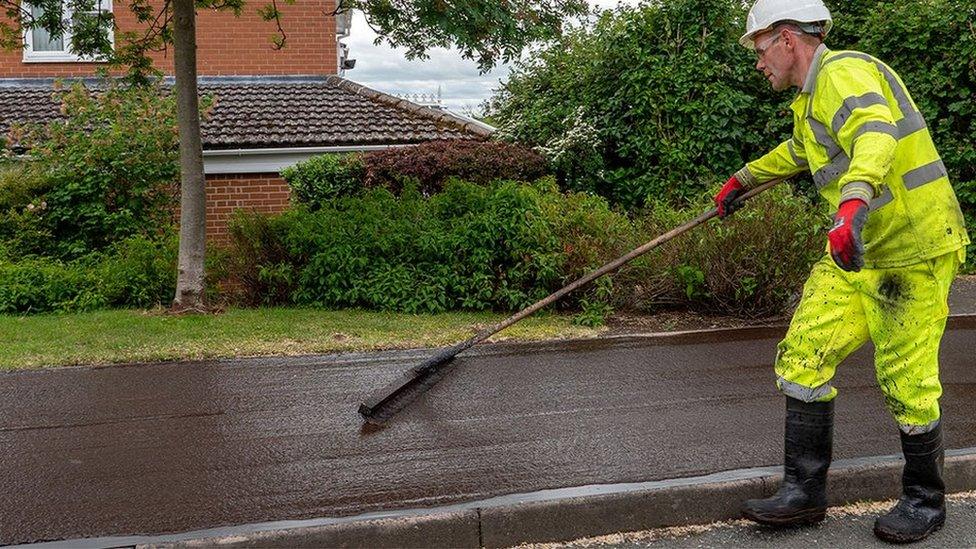 Man laying asphalt