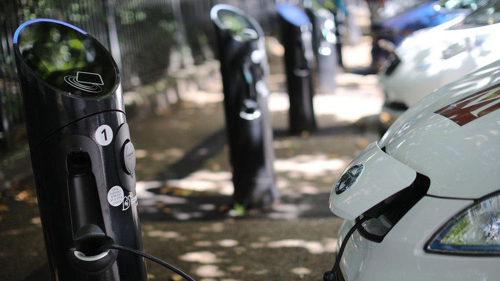 A charging plug connects an electric vehicle (EV) to a charging station on August 17, 2017 in London