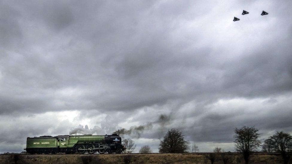 Three RAF Tornados fly past the Tornado train near Leeming Bar in Yorkshire during their farewell tour.