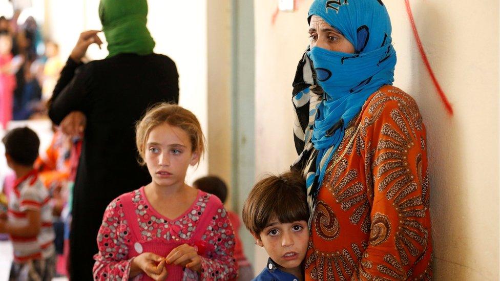 Civilians who fled their homes due to clashes on the outskirts of Falluja, gather in the town of Garma, Iraq, May 30, 2016