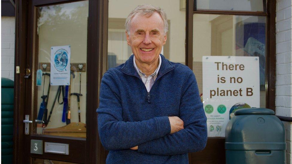 Dave Green beside a "There is no Planet B" poster