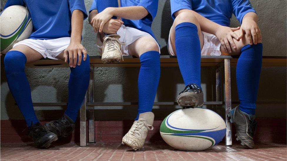 Rugby players on a bench