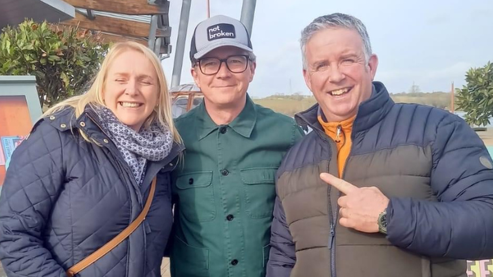 Michael Duignan and his wife posing for a photo with Rick Astley