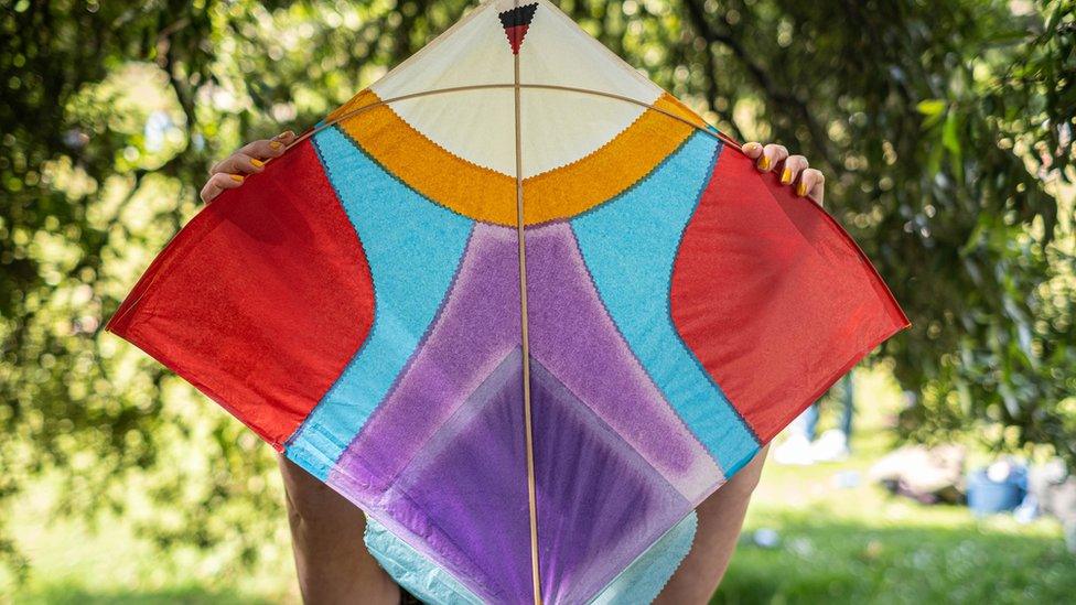 Boy holding up a kite