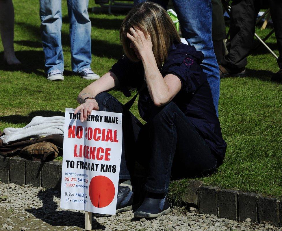 A protester reacts with dismay after the decision is announced