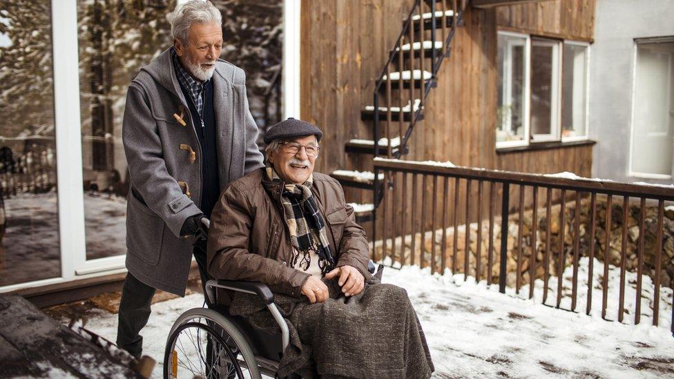 Close up of two seniors friends spending time on the porch