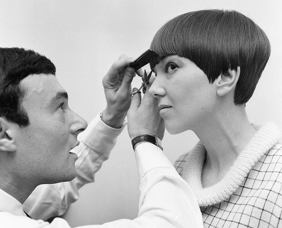 Fashion designer Mary Quant seen here having the finishing touches made to her new hairstyle by Vidal Sassoon 12th November 1964