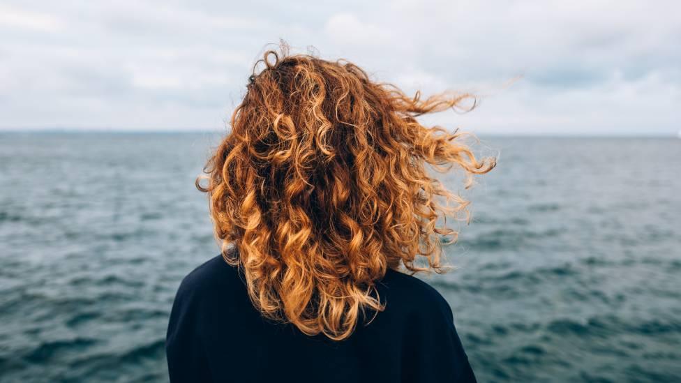 A woman from looking out over the sea