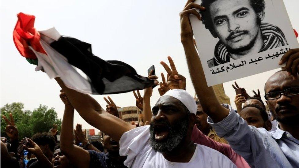 People shout slogans as they march on the streets demanding the ruling military hand over to civilians during a demonstration in Khartoum, 30 June 2019