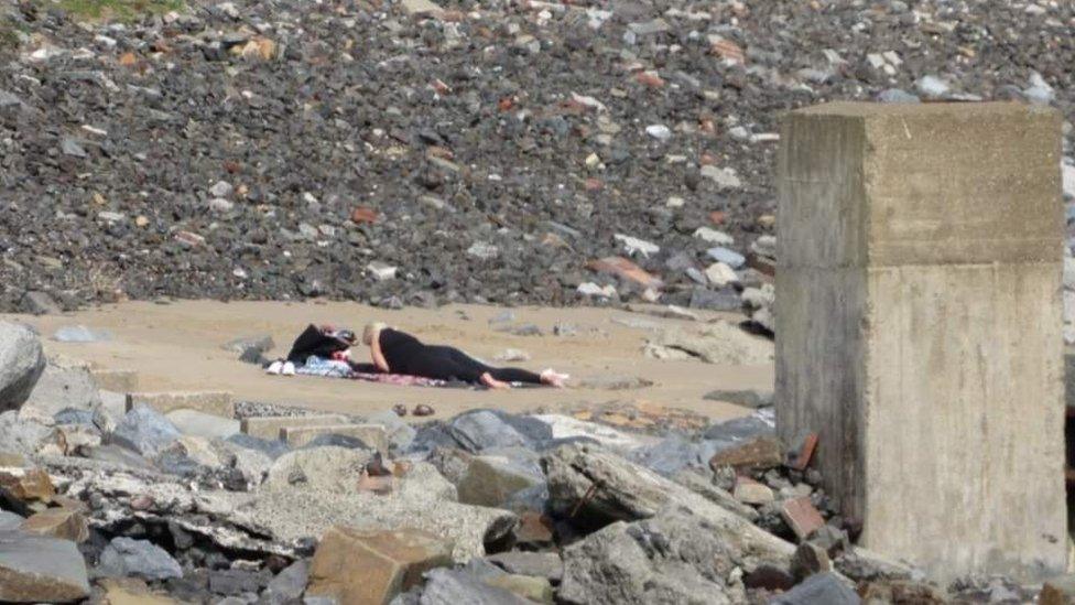 Woman sunbathing on beach