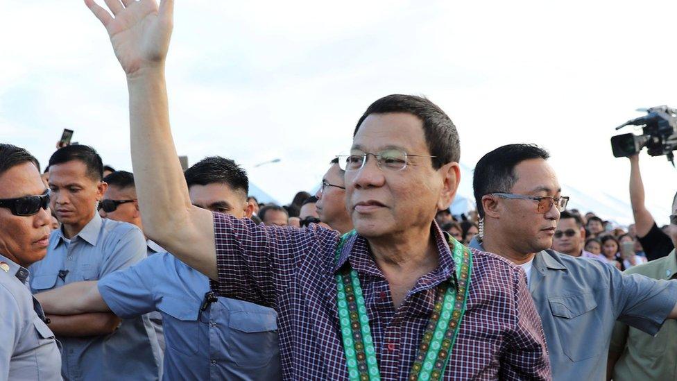 Duterte greets supporters during an airport inspection in Cagayan province