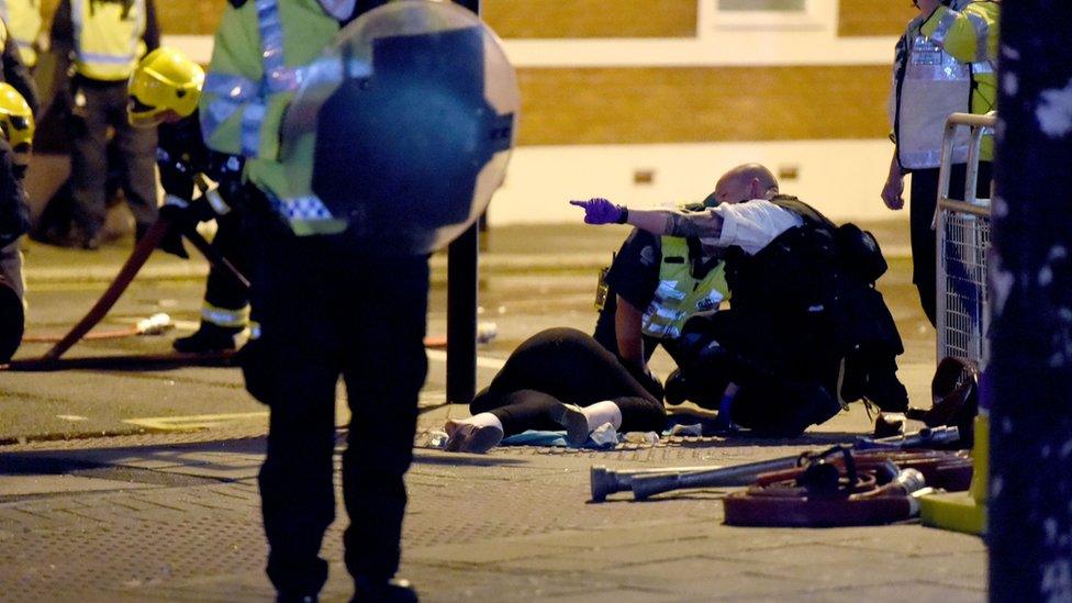 Police tend to a woman on the floor