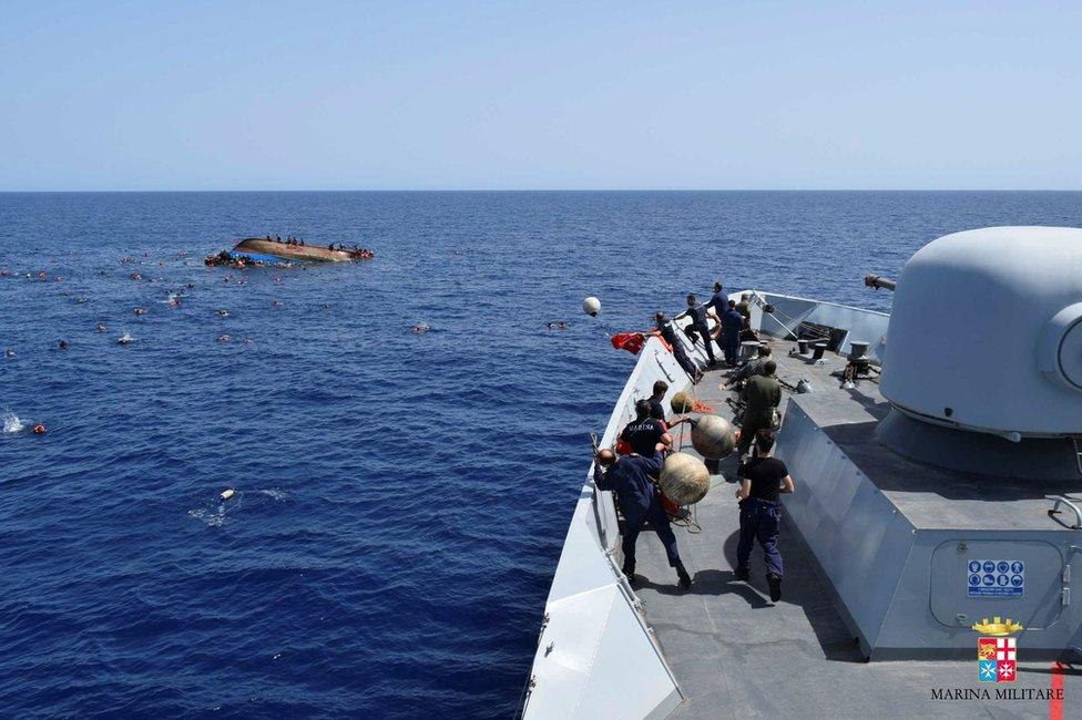Migrants escape from a capsizing boat in the Mediterranean, 25 May
