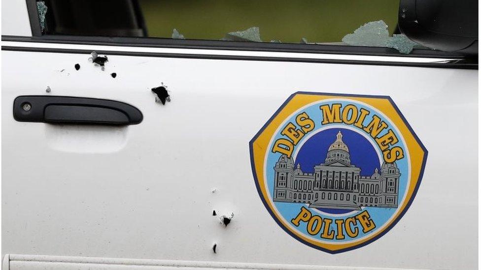 Bullet holes are seen on the side of a Des Moines Police Department squad car at the scene of a shooting, Wednesday, Nov. 2, 2016, in Des Moines, Iowa