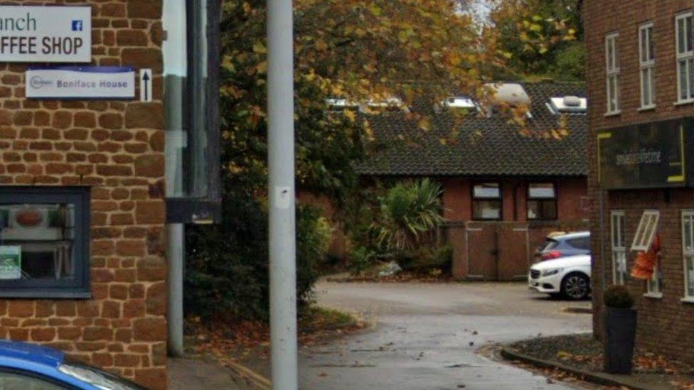 View of single-story brick care home taken from car park